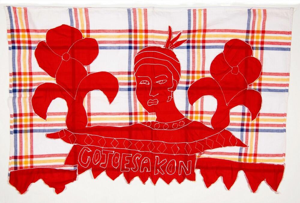 Wikkeldoek met ruitmotieven en appliquéwerk