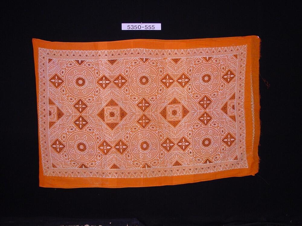 Oranje hoofddoek met bedrukte ornamenten van cirkels en ruiten waarbinnen figuren