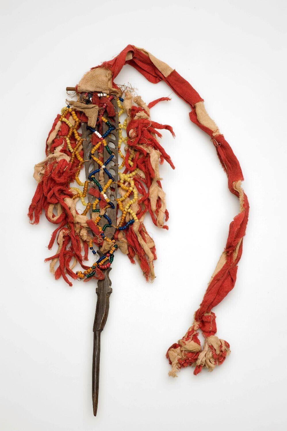 Hair ornament, decorated with beads and red cotton