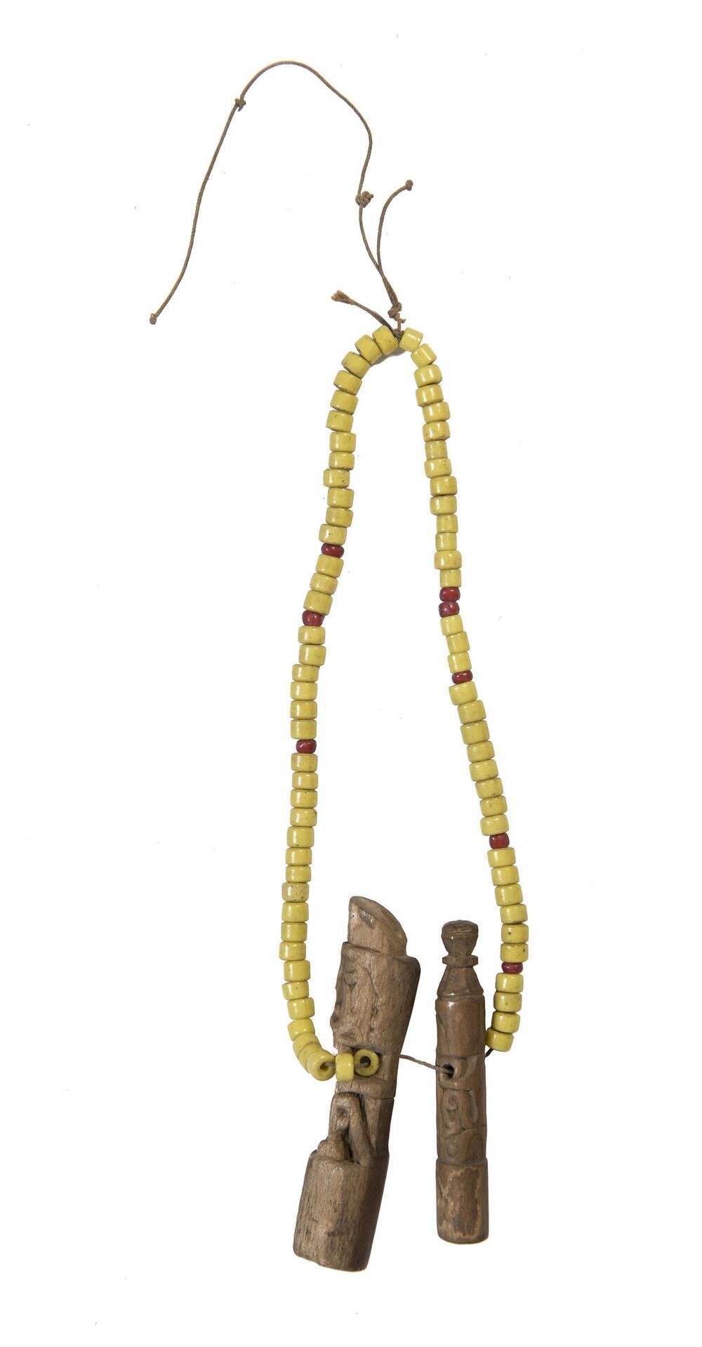 Necklace of yellow beads with two korwar looking wooden amulets