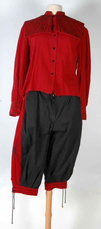 Zwarte kniebroek met steenrood zijpand