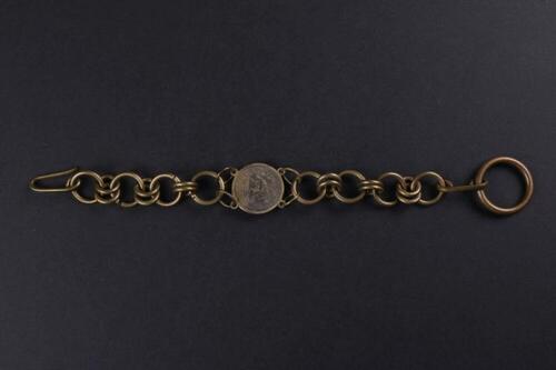 Armband in koperkleurig metaal met muntstuk