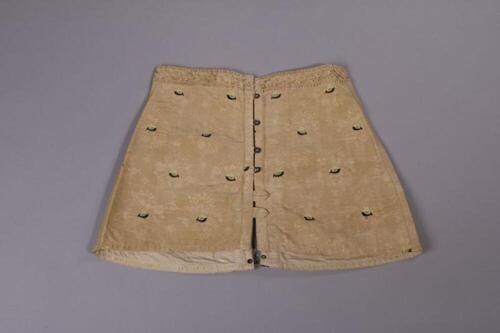 Ensemble bestaande uit beige korset en productverpakking