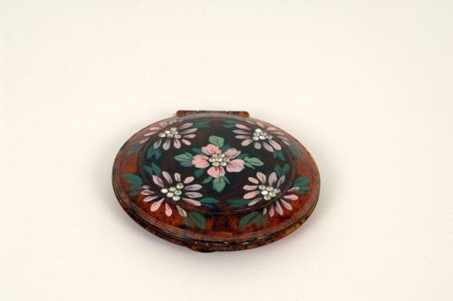 Poederdoos in bruin plastic versierd met bloemenprint