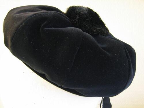 Baret in zwarte fluweel met pompon in zwarte imitatiebont