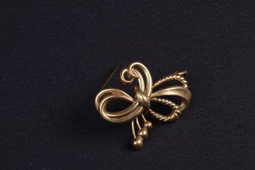 Broche in goudkleurig metaal