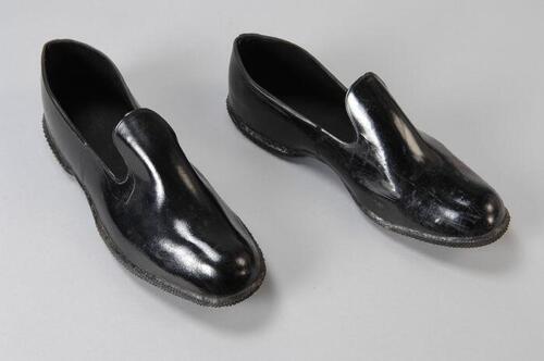 Zwarte rubbern overschoenen, laag model, horend bij een quarantaine pak van de GGD