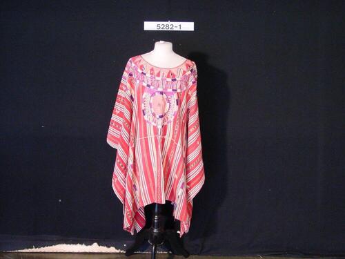 Lange gestreepte blouse met geborduurde versieringen, die bij processies wordt gedragen