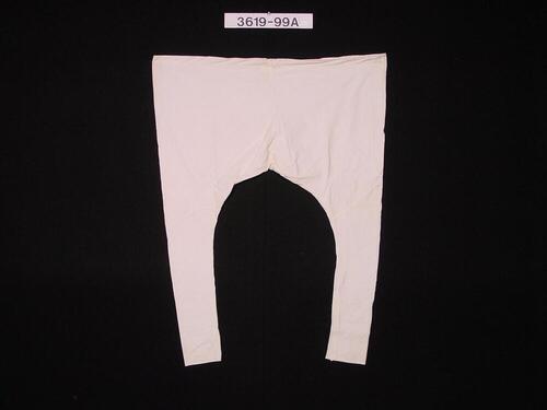 Witte katoenen broek met nauwe pijpen, onderdeel van mannenkostuum