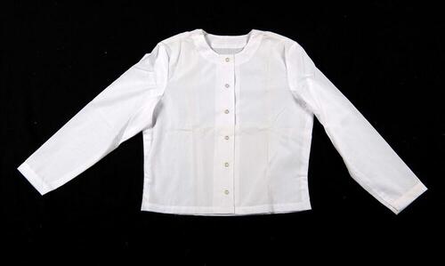 Een witte katoenen blouse, onderdeel van een driedelige kledingset van een non.