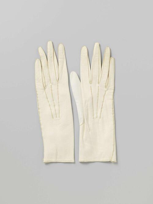 Handschoen van wit glacéleer met twee drukknopen van kunststof, versierd met drie uitstralende…